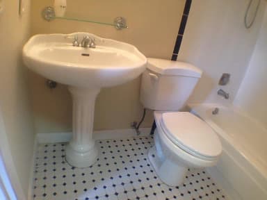 Bathroom with vanity, tub, and tile flooring