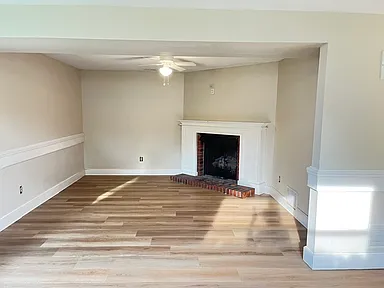 Living room with fireplace and updated flooring